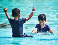 Children's at waterpark playing with water, enjoying aqua play station, Wavepool